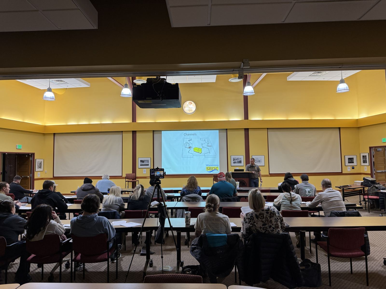 A Jumpstart class in a large meeting room with a presentation on screen